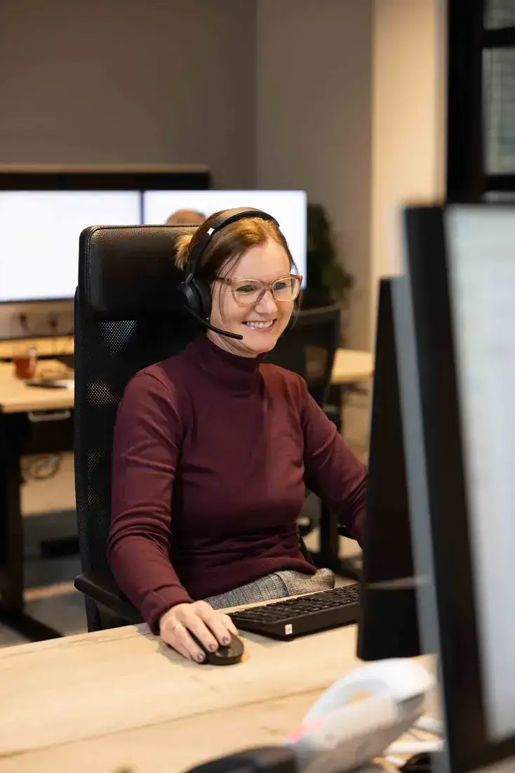Medewerker met headset aan het werk in een klantcontactcentrum
